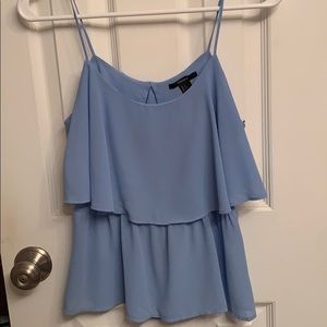 Light blue, open back, flowy tank